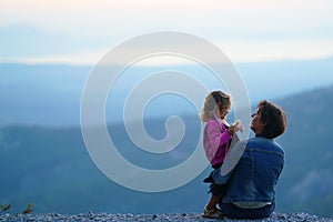 Happy mother and daughter against the backdrop of the enchanted nature of the mountain in Euboea, Greece