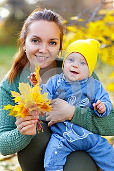 Happy mother and daughter in the autumn park.