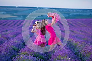 Happy mother and daughter child together with yellow dandelion flowers in summer day enjoy vacation free time together happy