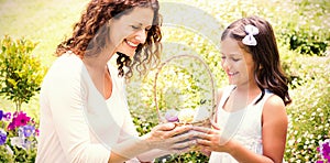 Happy mother and daughter collecting easter eggs