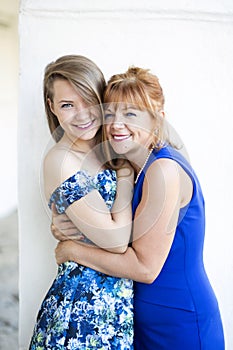Happy mother and daughter dressed in blue