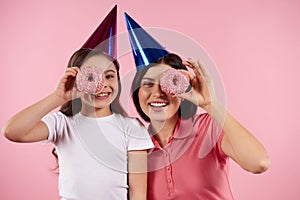 Happy mother and daughter in holiday caps