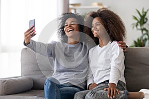 Happy mother and daughter make selfie together