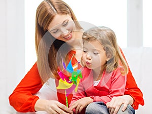 Happy mother and daughter with pinwheel toy