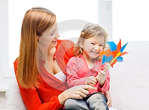 Happy mother and daughter with pinwheel toy
