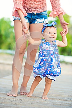 Happy mother and daughter portrait. Family holiday by the sea. learn to walk