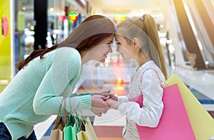 Happy mother and daughter with shopping bags. Shopping time with family