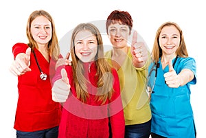 Happy mother with daughter and the young female doctors