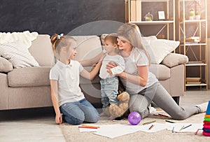 Happy mother drawing with her children