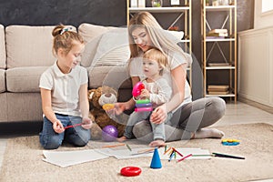 Happy mother drawing with her children