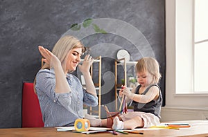 Happy mother drawing with her daughter