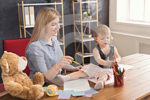 Happy mother drawing with her daughter