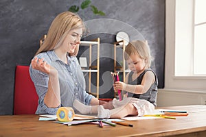 Happy mother drawing with her daughter