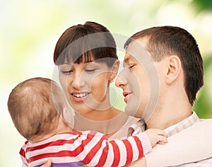 Happy mother and father with adorable baby