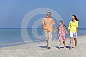 Happy Mother, Father and Daughter Family on Beach