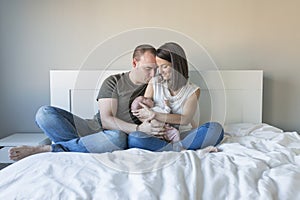 happy mother and father with her baby girl at home. Lifestyle indoors and family love concept