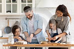 Happy mother and father with two kids baking together