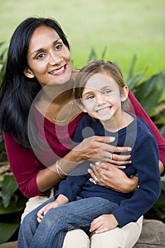 Happy mother with five year old son on lap