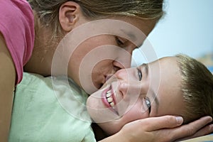 Happy mother gives her son a kiss before sleep and wish good night and beautiful dreams