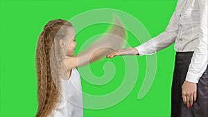 Happy mother giving high five to her little daughter on a Green Screen, Chroma Key