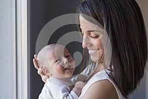 happy mother with her baby girl at home. Lifestyle indoors and family love concept