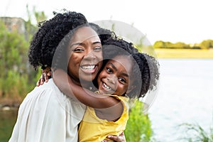 Happy mother and her beautiful daughter smiling.