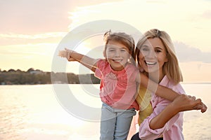 Happy mother and her child on beach. Spending time in nature