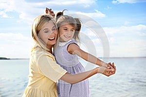 Happy mother and her child on beach. Spending time in nature