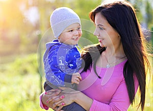 Happy Mother and her Child enjoy the early Spring in Park