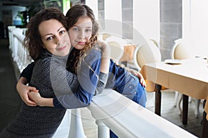 Happy mother and her daughter embrace in photo