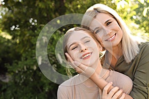 Happy mother with her daughter spending time together in park on day