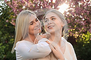 Happy mother with her daughter spending time together in park on sunny day