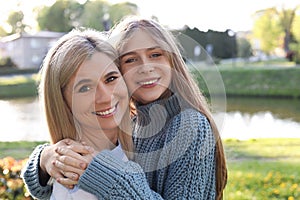 Happy mother with her daughter spending time together in park on sunny day