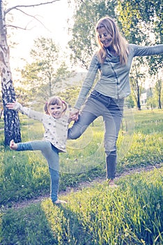 Happy mother and her little daughter having fun