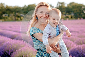 Happy mother and her little son phaving fun in a lavender field