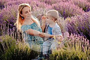 Happy mother and her little son phaving fun in a lavender field