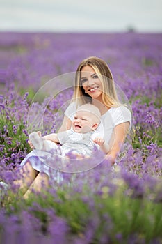 Happy mother and her little son posing in a lavender field