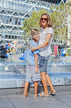 Happy mother and her son having fun near Pompidou Center in Paris. Tourists enjoying their vacation in France.