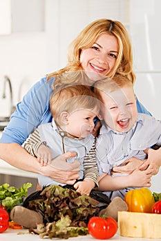 Happy mother with her sons in the kitchen