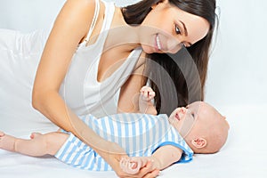 Happy mother holding a baby boy at white background