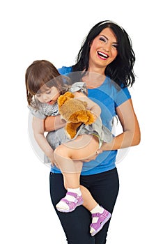 Happy mother holding toddler girl