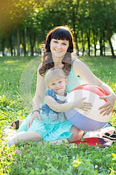 Happy mother hugging her daughter in nature