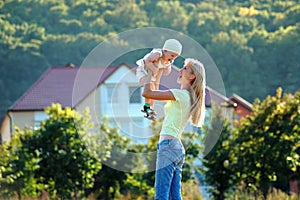 Happy mother keeps child on hand