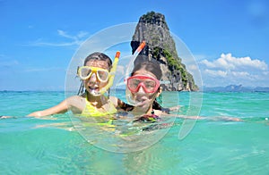 Happy mother and kid snorkeling in tropical sea