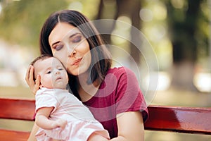 Happy Mother Kissing Her Cute Adorable Baby Girl