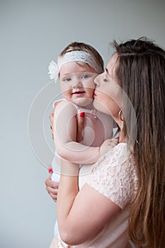 Happy mother kissing her smiling baby