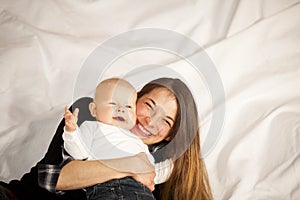 Happy mother with laughing baby girl