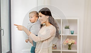 Happy mother with little baby boy at home