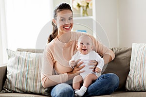 Happy mother with little baby boy at home