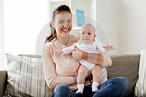 Happy mother with little baby boy at home
